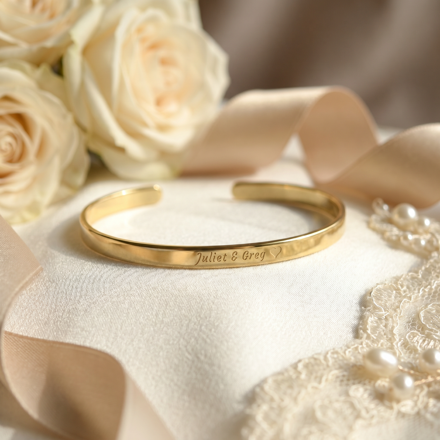 gold bracelet with names and heart symbol